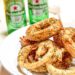 onion rings on a plate with chocolate coin and beer bottles in the background